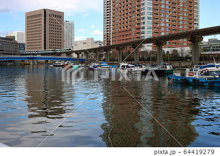 Tokyo Monorail train in front of highrise apartment by Tokyo Bay Tokyo Monorail train in front of highrise apartment by Tokyo Bay 64419279