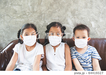 Asian children boy and girls wearing protection mask stay at home quarantine from the coronavirus Asian children boy and girls wearing protection mask stay at home quarantine from the coronavirus 64419327