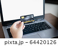 Women's hand holding credit card and using laptop for shopping online 64420126