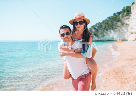 Young couple on white beach during summer vacation. Young couple on white beach during summer vacation. 64423763