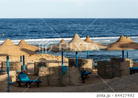Red Sea beach with straw umbrellas - Marsa Alam Egypt Africa  64427492