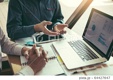 Manager is sitting to explain about the cost of Manager is sitting to explain about the cost of 64427647