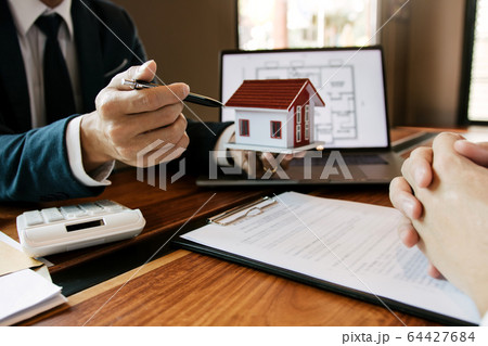 Business people home sales broker is using a pen 64427684