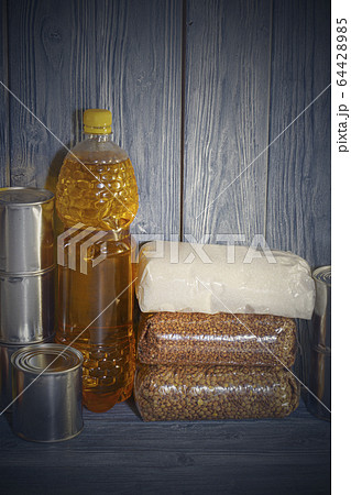 canned food and various cereals on a wooden shelf, food crisis canned food and various cereals on a wooden shelf, food crisis 64428985