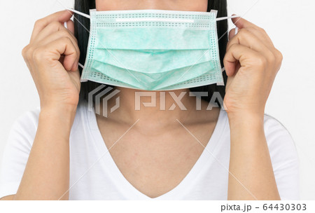 A woman wears a face mask that protects against the spread of Coronavirus 64430303