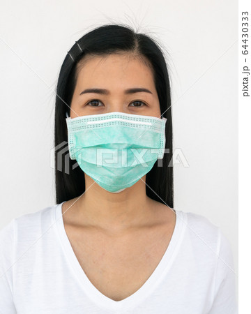 A woman wears a face mask that protects against the spread of Coronavirus A woman wears a face mask that protects against the spread of Coronavirus 64430333
