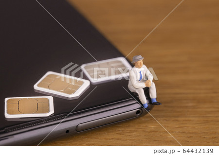 スマートフォンの契約について考えるビジネスマン 64432139