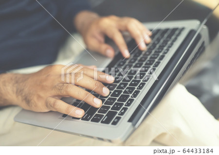 lifestyle man close up hand keyboard sit work on sofa 64433184