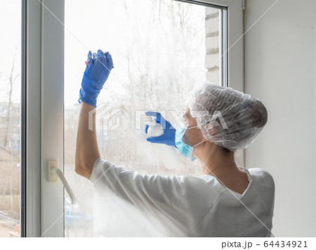 People in making disinfection on windows. People in making disinfection on windows. 64434921