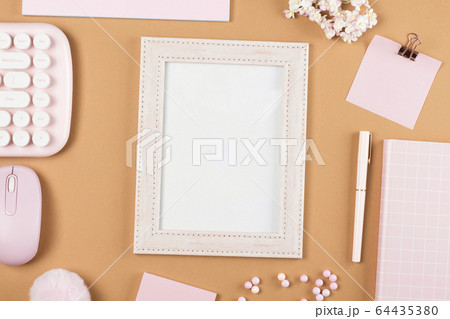 flat lay stationery on work desk in brown pastel background 64435380