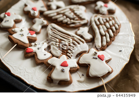 Homemade cookies in shape of angels and wings. 64435949