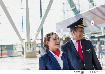 Portrait of mature pilot and attractive flight Portrait of mature pilot and attractive flight 64437593