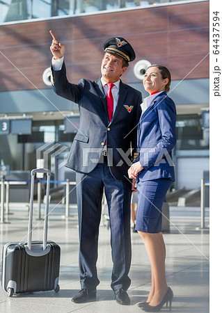 Pilot pointing aircraft while talking to flight Pilot pointing aircraft while talking to flight 64437594