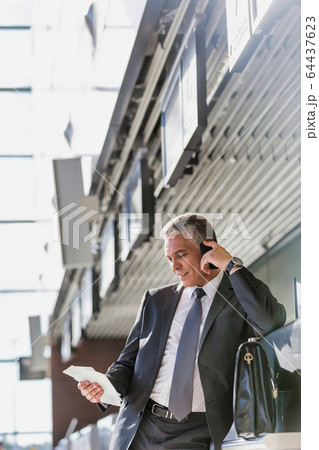 Portrait of mature businessman talking on Portrait of mature businessman talking on 64437623
