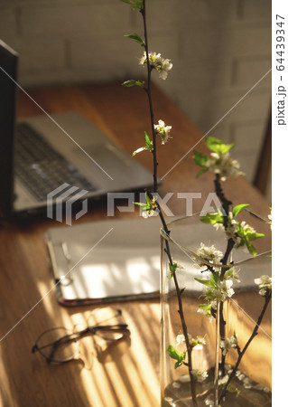 Minimalistic workplace at home on a wooden table in the shadows. Minimalistic workplace at home on a wooden table in the shadows. 64439347