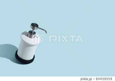 Dispenser for liquid soap on a blue background. Place for text Dispenser for liquid soap on a blue background. Place for text 64439359