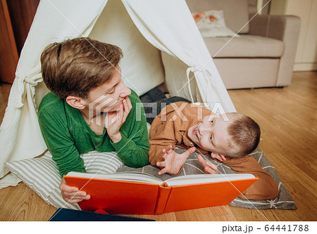 Mom son lie together hut read book 64441788