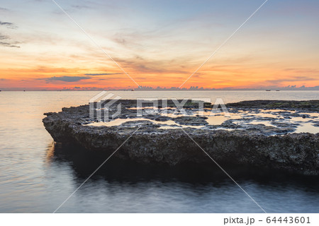 Lovely orange sunset and idyllic water surface in the sea  64443601