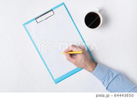 Male hand writing on paper. Top view of documents 64443650