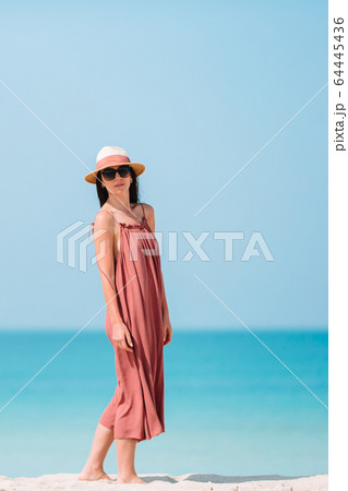 Happy girl background the blue sky and turquoise water in the sea on caribbean island Happy girl background the blue sky and turquoise water in the sea on caribbean island 64445436
