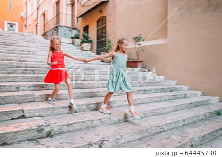 Adorable fashion little girls outdoors in European city Adorable fashion little girls outdoors in European city 64445730