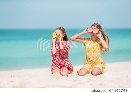 Cute little girls at beach during summer vacation Cute little girls at beach during summer vacation 64445743