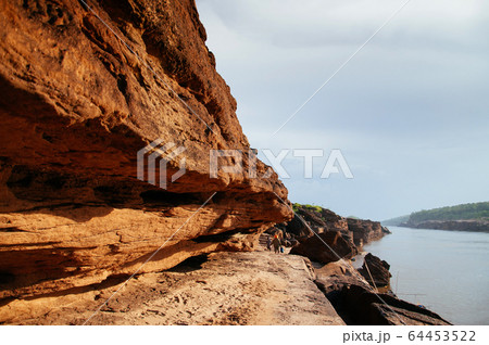 Large Sand stone canyon cliff shoreline of Mekong 64453522