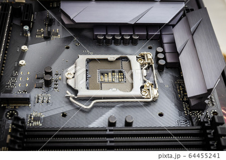 Closeup detail of CPU socket of a modern computer black motherboard. Electronic small component details. Select focus Closeup detail of CPU socket of a modern computer black motherboard. Electronic small component details. Select focus 64455241
