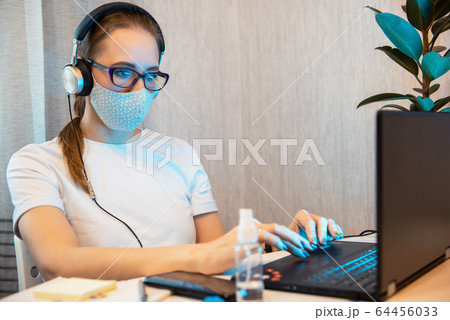 Woman in quarantine for coronavirus working from home 64456033