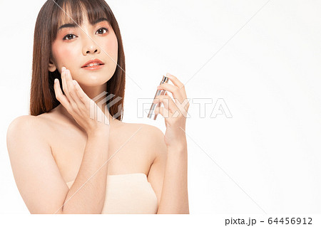 Beauty asian woman  brown hair looking smile in camera happiness and hold bottle cosmetic cream lotion  and cheerful with make up brush,Beauty Concept on white background. 64456912