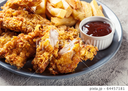Chicken strips in cornflakes breadcrumb 64457181