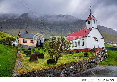 Very small village with church in Faroe Islands 64458259