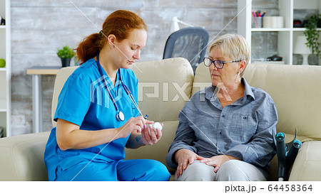 Female doctor consultin a senior woman about pills dosage and subscription Female doctor consultin a senior woman about pills dosage and subscription 64458364