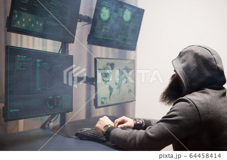 Side view of bearded hacker with a hoodie Side view of bearded hacker with a hoodie 64458414