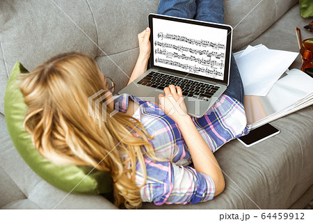 Young woman studying at home during online courses or free information by herself Young woman studying at home during online courses or free information by herself 64459912