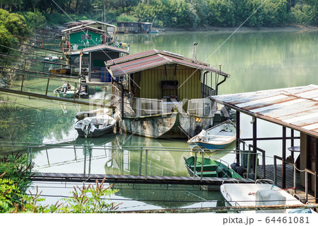 houseboat parked by the river near the swamp 64461081