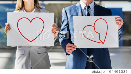 Man and woman holding white placard with a heart 64461085