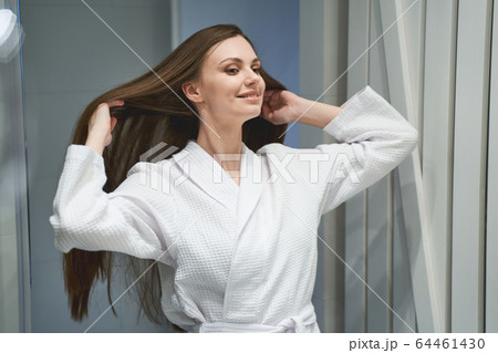 Contented cute girl standing in the bathroom 64461430