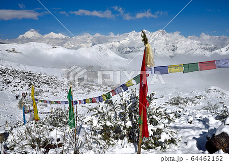 Buddhist Prayer flags against snowy peaks 64462162