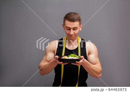 Man holding a box full of protein rich foods for sports nutrition Man holding a box full of protein rich foods for sports nutrition 64463973
