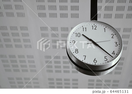 Big White Classic Clock Hanging from the Ceiling 64465131