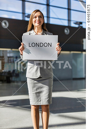 Portrait of attractive woman standing while Portrait of attractive woman standing while 64465675