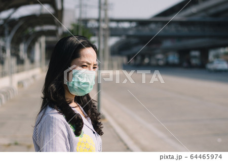 People wearing mask to protect against viruses and dust in the city. 64465974