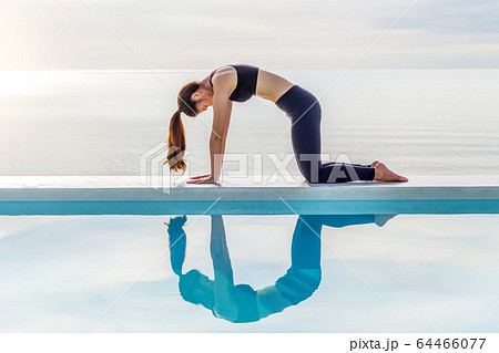 Asian young woman practice yoga Cow pose on the beach with beautiful sea in the morning,Feeling so comfortable and relax in holiday,Healthy Concept Asian young woman practice yoga Cow pose on the beach with beautiful sea in the morning,Feeling so comfortable and relax in holiday,Healthy Concept 64466077