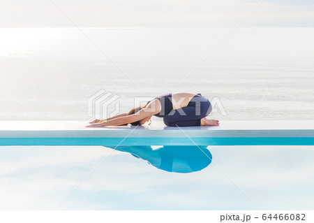 Asian woman practice yoga Child's Pose on the beach in the morning,Feeling so comfortable and relax in holiday,Healthy Concept Asian woman practice yoga Child's Pose on the beach in the morning,Feeling so comfortable and relax in holiday,Healthy Concept 64466082