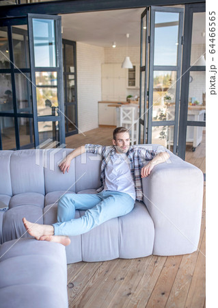 Young man in a checkered shirt looking relaxed 64466565