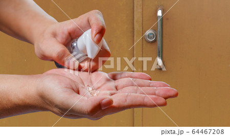man applying alcohol gel cleaning hands after man applying alcohol gel cleaning hands after 64467208