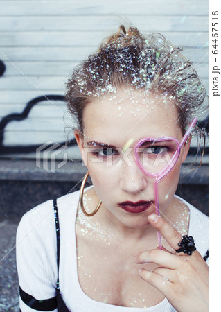young pretty party girl smiling covered with glitter tinsel, fashion lifestyle people concept 64467518