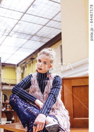 young pretty blond girl posing in fashion style at vintage europe hall interior, lifestyle rich people concept 64467578