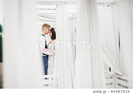 Romantic wedding moment, couple of newlyweds smiling portrait, bride and groom hugging Romantic wedding moment, couple of newlyweds smiling portrait, bride and groom hugging 64467910